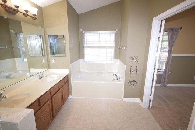 bathroom featuring lofted ceiling, tile patterned floors, a chandelier, vanity, and a washtub