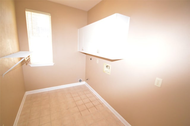 laundry room featuring cabinets, hookup for a gas dryer, hookup for a washing machine, hookup for an electric dryer, and light tile patterned flooring