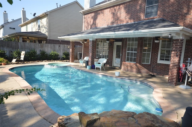 view of pool with a patio area and an in ground hot tub