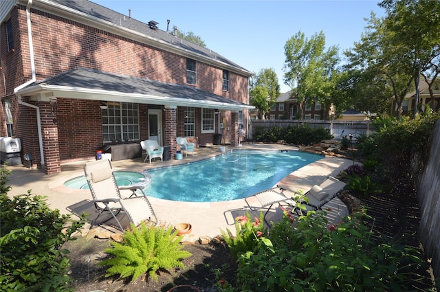 view of pool featuring an in ground hot tub and a patio