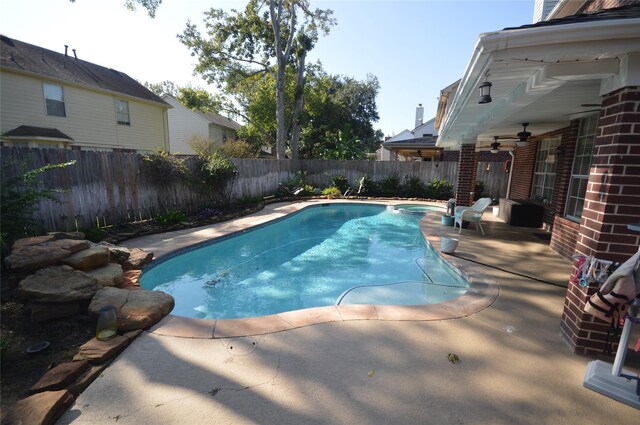 view of swimming pool featuring ceiling fan and a patio area