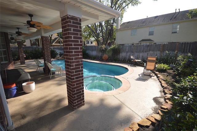 view of pool with ceiling fan, a patio, and an in ground hot tub