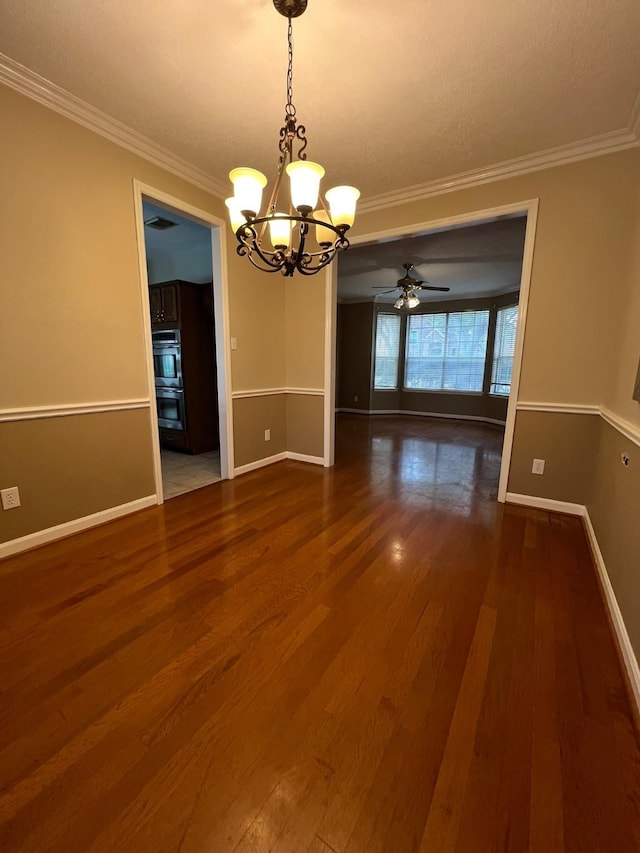 unfurnished dining area featuring hardwood / wood-style flooring, ornamental molding, and ceiling fan with notable chandelier