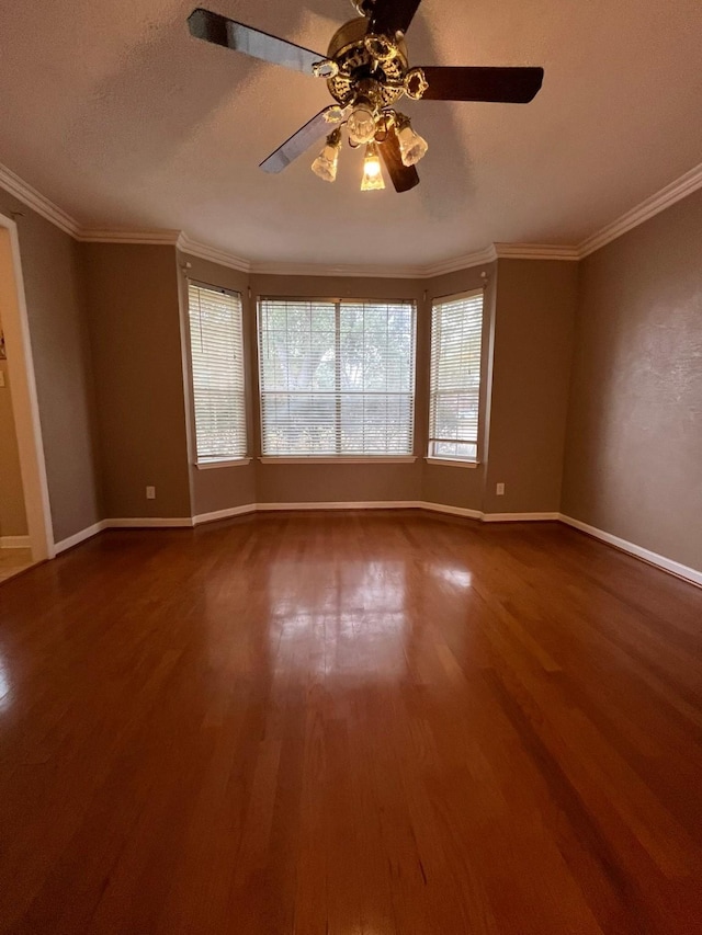 unfurnished room with ceiling fan, wood-type flooring, ornamental molding, and a textured ceiling