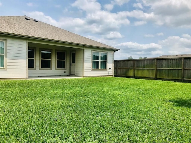 rear view of property with a lawn