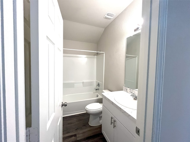 full bathroom featuring vanity, vaulted ceiling, shower / washtub combination, wood-type flooring, and toilet