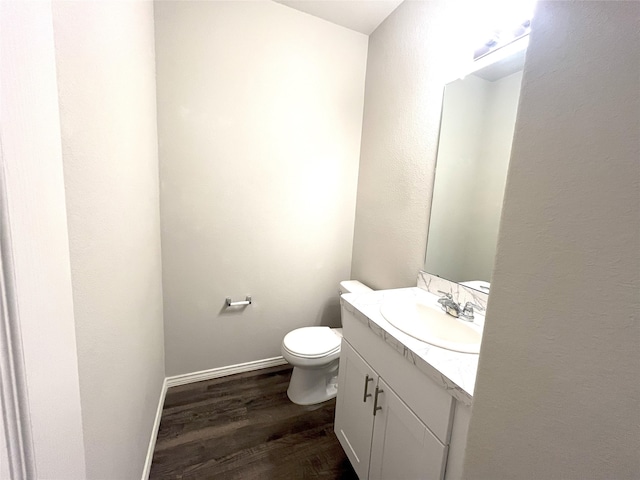 bathroom featuring hardwood / wood-style floors, vanity, and toilet