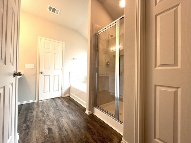 bathroom featuring independent shower and bath, wood-type flooring, and lofted ceiling