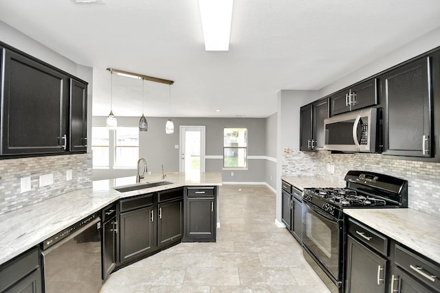 kitchen featuring sink, stainless steel appliances, tasteful backsplash, light stone counters, and pendant lighting