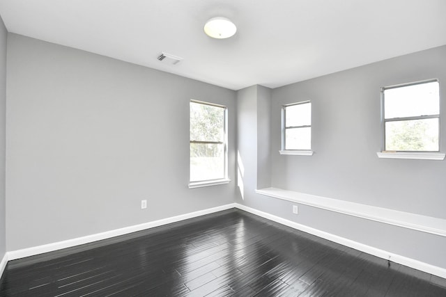 spare room featuring dark hardwood / wood-style flooring