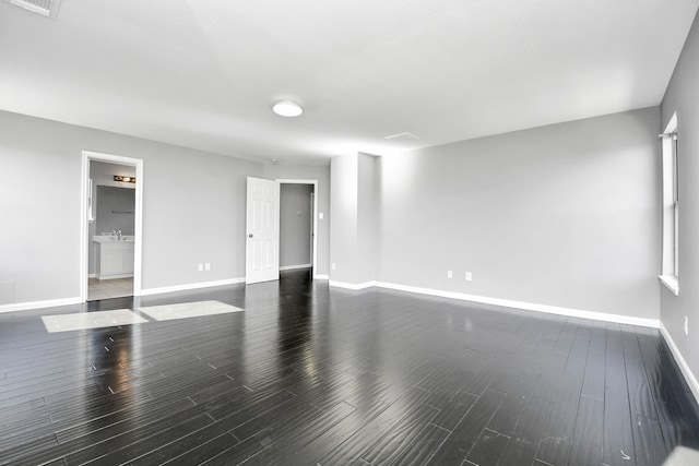 spare room featuring dark hardwood / wood-style flooring