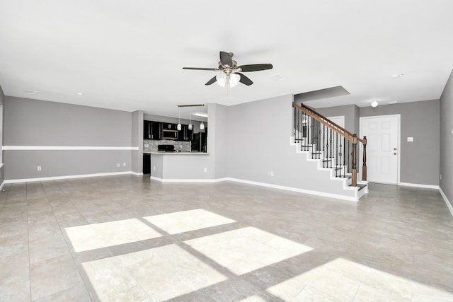 unfurnished living room featuring ceiling fan