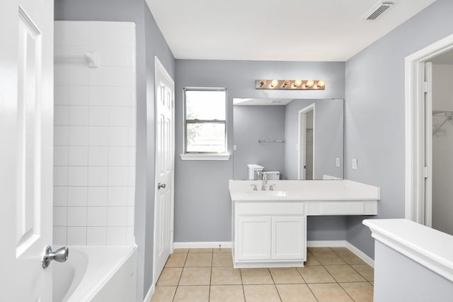 bathroom featuring tile patterned flooring, vanity, and tiled shower / bath combo