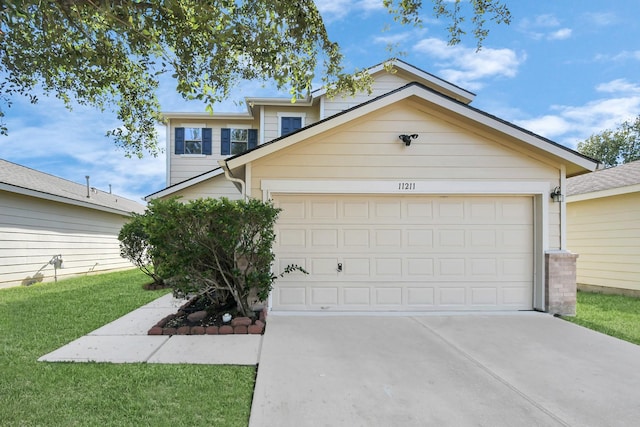 view of front of property featuring a front yard and a garage