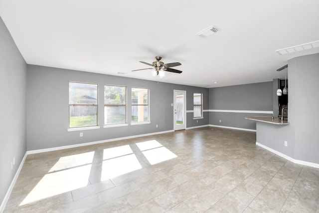 unfurnished living room featuring ceiling fan