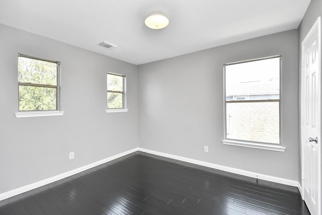 empty room featuring dark hardwood / wood-style flooring