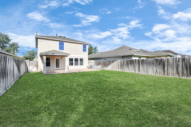 rear view of property featuring a yard and a patio area