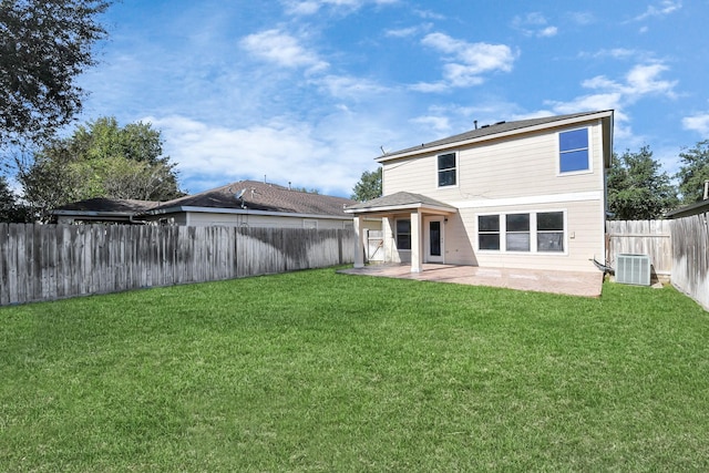 rear view of property featuring a lawn, central AC unit, and a patio area