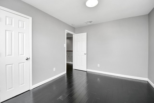 unfurnished bedroom featuring dark hardwood / wood-style flooring