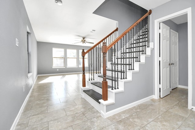 staircase with tile patterned floors and ceiling fan