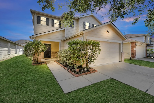 view of front of property featuring a lawn and a garage