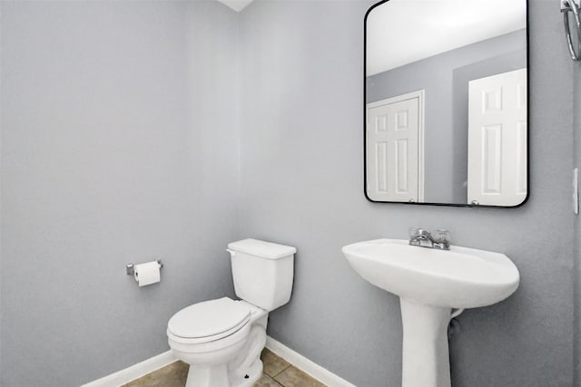 bathroom with tile patterned flooring and toilet