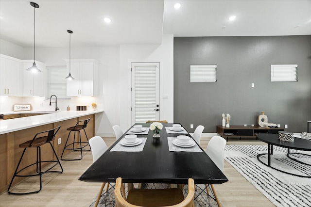 dining room with sink and light hardwood / wood-style floors