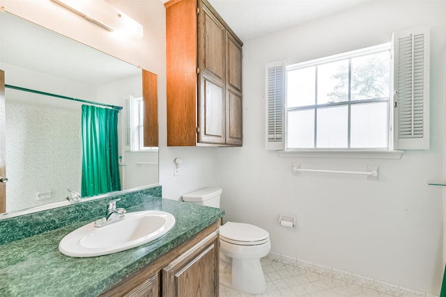 bathroom with vanity, toilet, and walk in shower