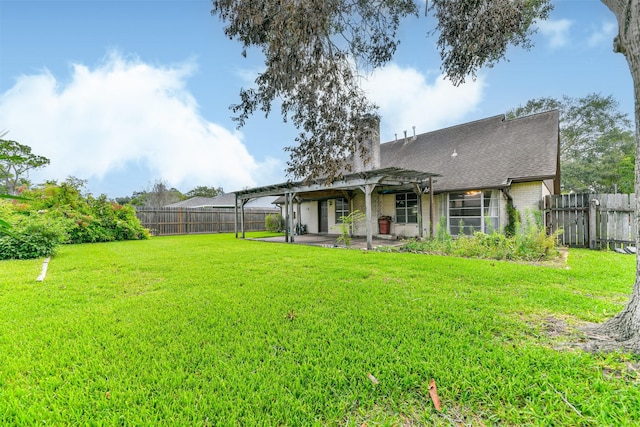 rear view of house with a pergola, a patio area, and a lawn