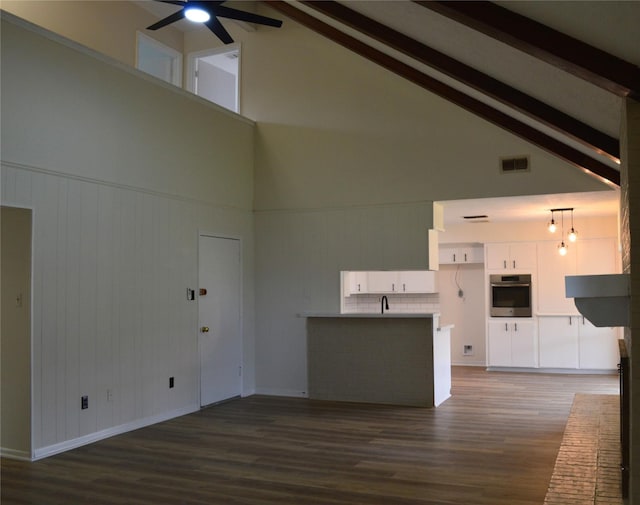 unfurnished living room with beam ceiling, ceiling fan, high vaulted ceiling, and dark hardwood / wood-style floors