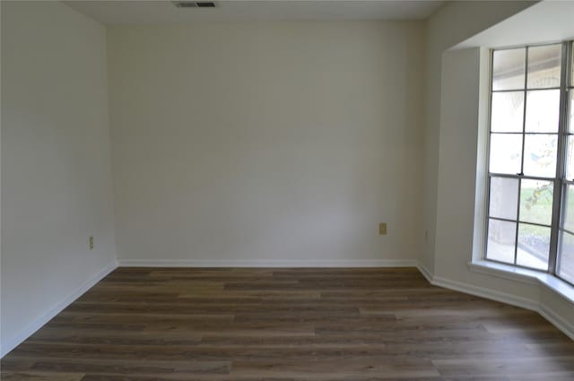 unfurnished room featuring dark hardwood / wood-style flooring