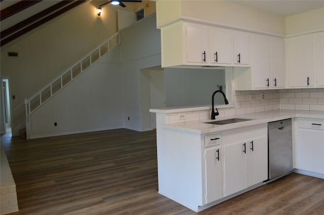 kitchen featuring dishwasher, sink, dark wood-type flooring, kitchen peninsula, and white cabinets