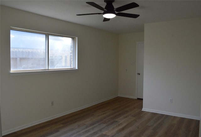 spare room featuring ceiling fan and dark hardwood / wood-style flooring