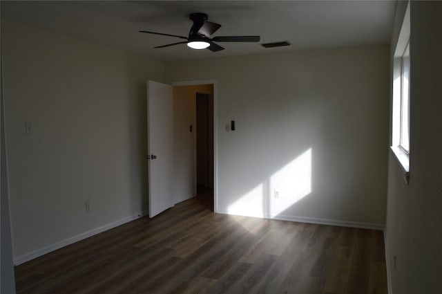 empty room featuring dark hardwood / wood-style floors and ceiling fan