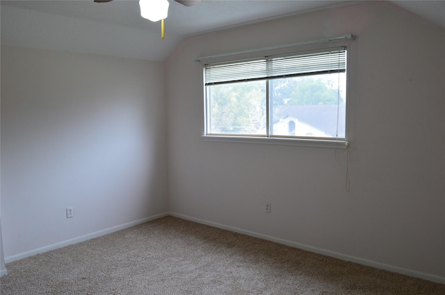 empty room featuring carpet floors, plenty of natural light, lofted ceiling, and ceiling fan