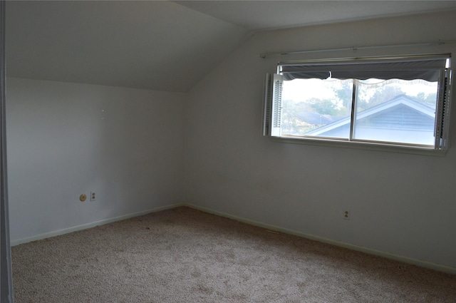 bonus room with light carpet and lofted ceiling