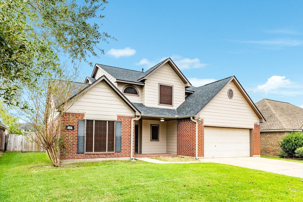 view of front of property with a front yard and a garage