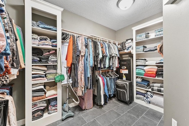 spacious closet with dark tile patterned flooring