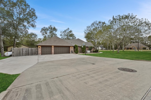 view of front facade with a front yard and a garage