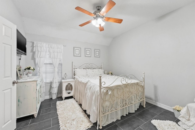 tiled bedroom featuring ceiling fan and lofted ceiling