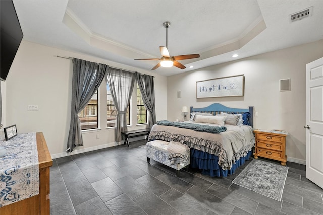 bedroom featuring a raised ceiling, ceiling fan, and ornamental molding