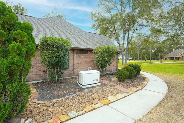 view of side of home with a lawn