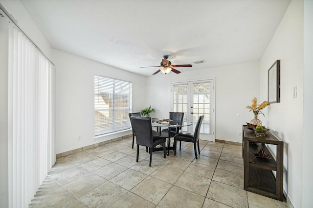 tiled dining area featuring ceiling fan, plenty of natural light, and french doors