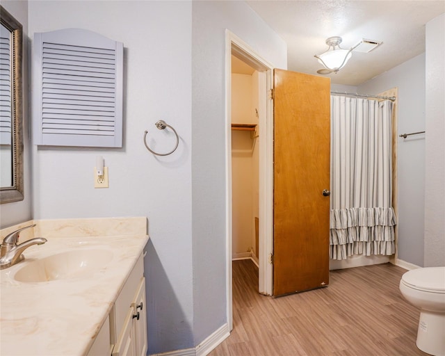 bathroom featuring a shower with curtain, vanity, toilet, and wood-type flooring