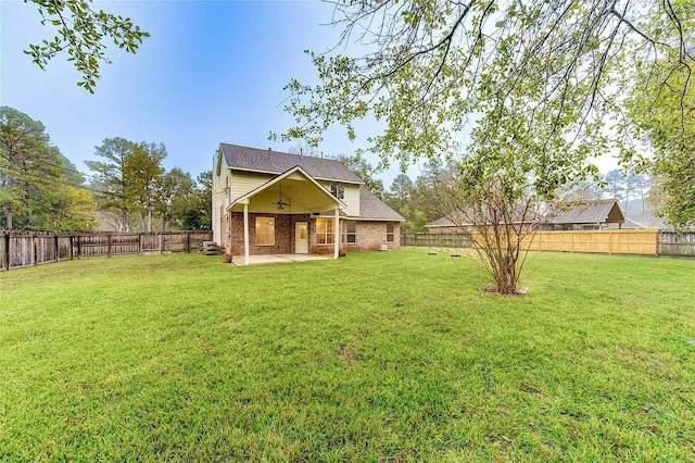 exterior space with a lawn, ceiling fan, and a patio