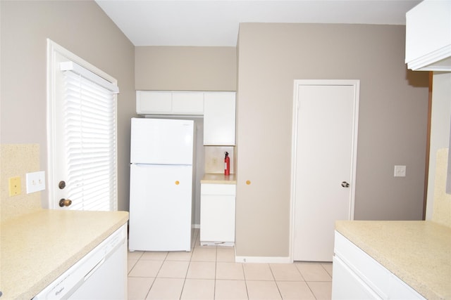 kitchen featuring white cabinets, white appliances, and light tile patterned flooring