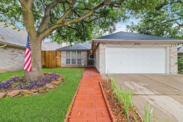 ranch-style home with a garage and a front lawn