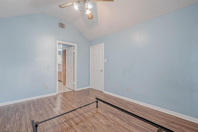 unfurnished room with vaulted ceiling, ceiling fan, and light wood-type flooring