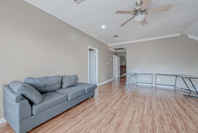 living room featuring ornamental molding, ceiling fan, a textured ceiling, and light hardwood / wood-style floors