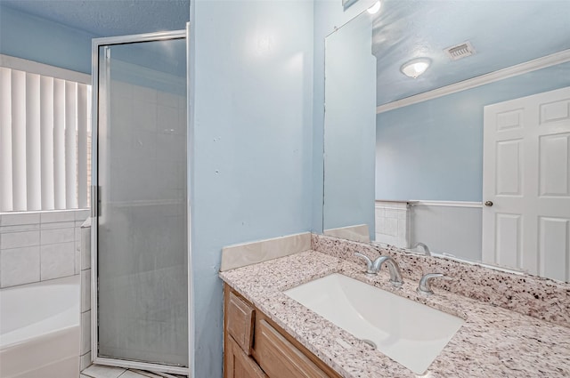 bathroom featuring ornamental molding, shower with separate bathtub, vanity, and a textured ceiling